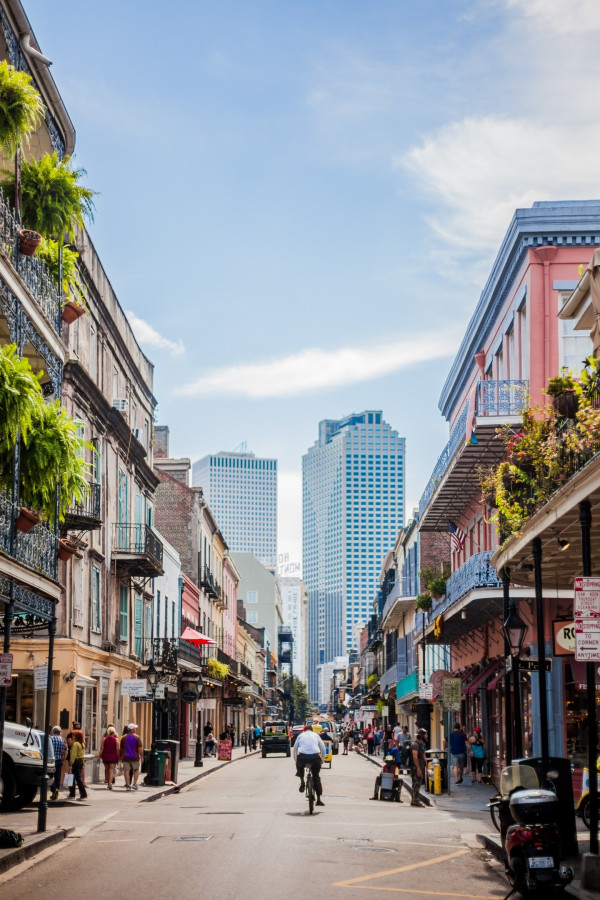 A street view of a city with buildings and balconies